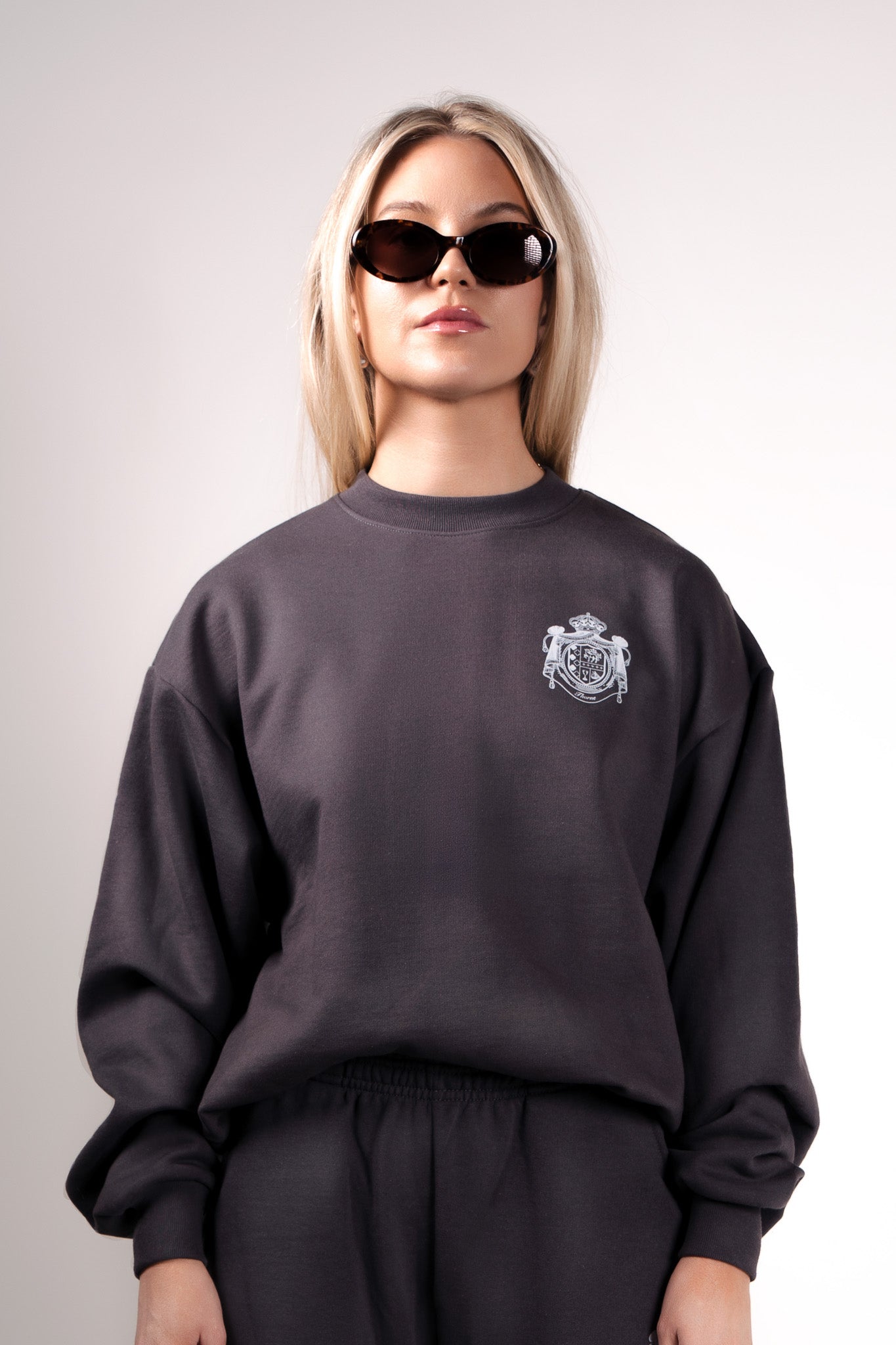 Quiet luxury crest crewneck in gray by Thorne Estate