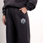 Close-up of Thorne Estate crest embroidery on the navy sweatpant details