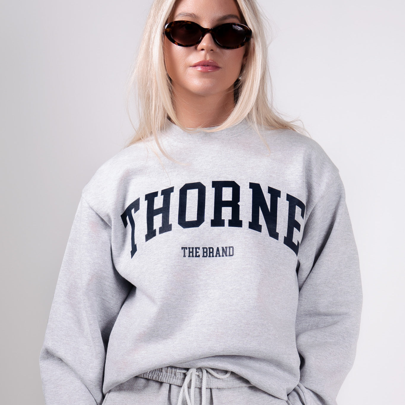 Front view of the varsity crewneck in gray by Thorne Estate