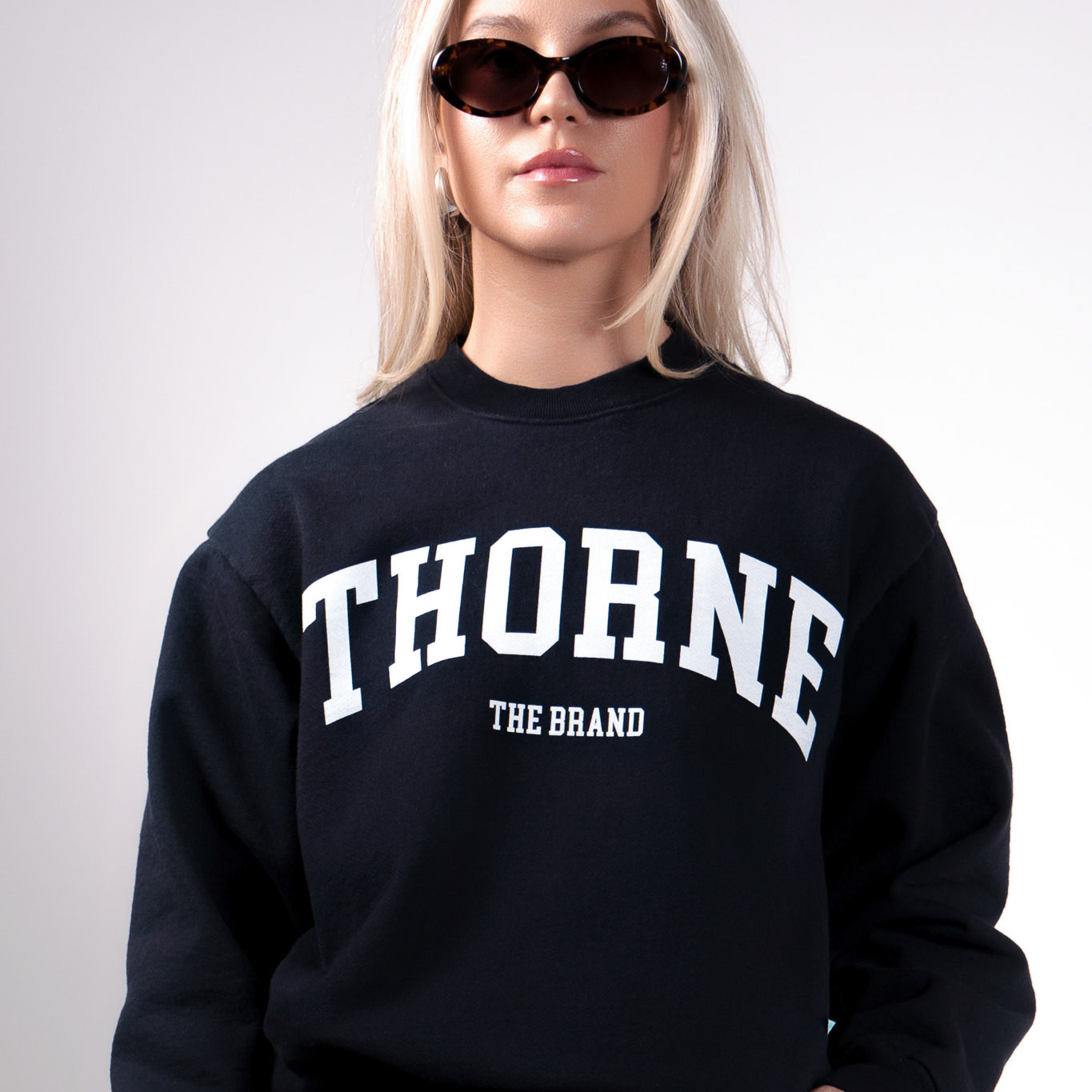 Quiet luxury varsity crewneck in navy by Thorne Estate