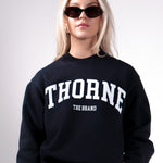 Quiet luxury varsity crewneck in navy by Thorne Estate