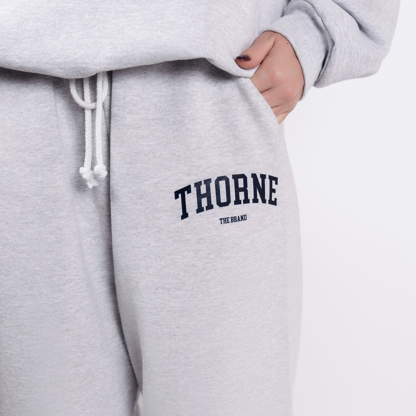 Close-up detail of Thorne Estate varsity logo in gray